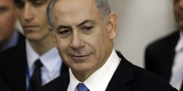 Israeli Prime Minister Benjamin Netanyahu reacts as he visits, on March 18, 2015, at the Wailing Wall in Jerusalem following