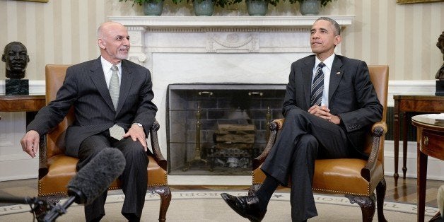 WASHINGTON, DC - MARCH 24: U.S. President Barack Obama poses with Afghan President Ghani during a restricted bilateral meeting in the Oval Office of the White House March 24, 2015 in Washington, DC. This marks the first meeting between the two presidents at the White House following the 2014 presidential election, which produced the first democratic transfer of power in Afghanistan's history. (Photo by Olivier Douliery-Pool/Getty Images)