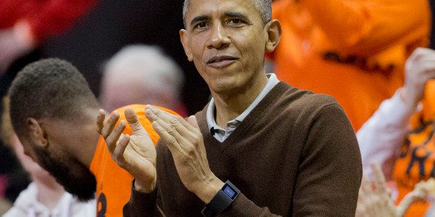 President Barack Obama applauds as he attends a Princeton vs Wisconsin-Green Bay women's college basketball game in the first round of the NCAA tournament in College Park, Md., Saturday, March 21, 2015. Obama's niece Leslie Robinson, plays for Princeton.(AP Photo/Pablo Martinez Monsivais)