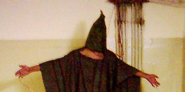 **ADVANCE FOR SUNDAY, MARCH 9--FILE** This is an image obtained by The Associated Press which shows an unidentified detainee standing on a box with a bag on his head and wires attached to him in this late 2003 file photo at the Abu Ghraib prison in Baghdad, Iraq. (AP Photo/File)