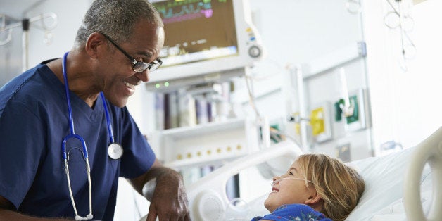 Young Girl Talking To Happy Smiling Male Nurse In Intensive Care Unit