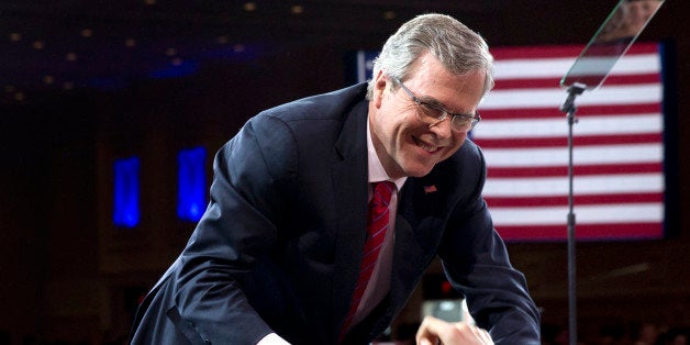 FILE - In this Feb. 27, 2015, file photo, former Florida Gov. Jeb Bush shakes hands with people in the audience after speaking at the Conservative Political Action Conference (CPAC) in National Harbor, Md. Bush has ended his relationships with the last two businesses he launched and helped lead since leaving the governor's office, clearing the way for an all-but-declared candidacy for president. (AP Photo/Carolyn Kaster, File)