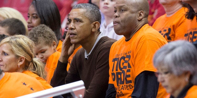 COLLEGE PARK, MD - MARCH 21: (AFP OUT) U.S. President Barack Obama (L) sits beside his brother-in-law Craig Robinson while a