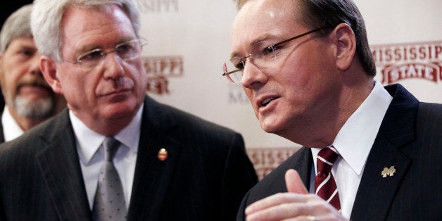 Ole Miss Chancellor Dan Jones, left, listens to Mississippi State President Mark Keenum discuss the details of their joint scholarship to lure bright students to teaching.at a Tuesday, Jan. 22, 2013 news conference in Jackson, Miss. The University of Mississippi and Mississippi State University will use a $12.9 million gift from the Hearin Foundation to fund scholarships for 20 students a year on each campus to study to become teachers. Students will receive full tuition, room, board and money to study abroad. (AP Photo/Rogelio V. Solis)