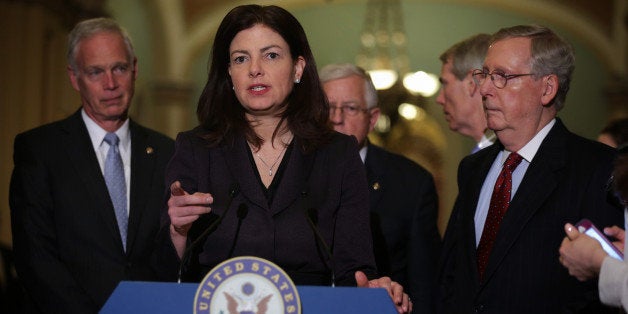 WASHINGTON, DC - MARCH 24: U.S. Sen. Kelly Ayotte (R-NH) (2nd L) speaks to members of the media as Sen. Ron Johnson (R-WI) (L), Sen. Michael Enzi (R-WY) (3rd L), Sen. Rob Portman (R-OH), and Senate Majority Leader Sen. Mitch McConnell (R-KY) (R) listen after the weekly Republican Policy Luncheon March 24, 2015 at the U.S. Capitol in Washington, DC. Senate Republicans held the luncheon to discuss GOP agenda. (Photo by Alex Wong/Getty Images)