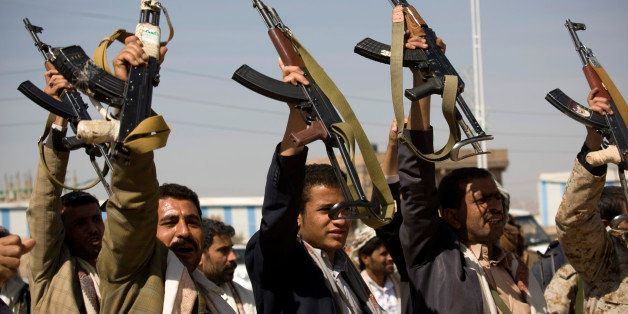 Houthi Shiite Yemeni raise their weapons during clashes near the presidential palace in Sanaa, Yemen, Monday, Jan. 19, 2015. Rebel Shiite Houthis battled soldiers near Yemen's presidential palace and elsewhere across the capital Monday, despite a claim of a cease-fire being reached to halt the violence, witnesses and officials said. (AP Photo/Hani Mohammed)