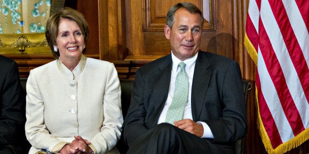 House Minority Leader Nancy Pelosi of Calif., left, and House Speaker John Boehner of Ohio, right, sit together during a ceremony to award the Congressional Gold Medal posthumously to Constantino Brumidi in recognition of his artistic contributions to the US Capitol building, Wednesday, July 11, 2012, on Capitol Hill in Washington. (AP Photo/J. Scott Applewhite)