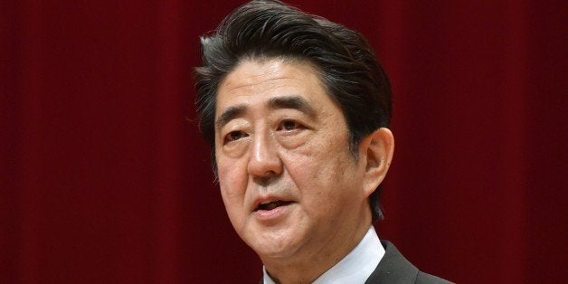 Japanese Prime Minister Shinzo Abe delivers a speech during the graduation ceremony of the National Defense Academy in Yokosuka, Kanagawa Prefecture on March 22, 2015. A total of 492 students graduated from the school this year. AFP PHOTO / KAZUHIRO NOGI (Photo credit should read KAZUHIRO NOGI/AFP/Getty Images)