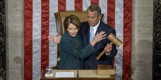 House Minority Leader Nancy Pelosi, D-CA, hands over the gavel to Speaker of the House John Boehner, R-OH, during a swearing-in ceremony in the House of Representatives as the 114th Congress convenes on Capitol Hill January 6, 2015 in Washington, DC. Republican John Boehner was re-elected and sworn in Tuesday as speaker of the US House of Representatives, overcoming a surprisingly robust attempt to oust him by two dozen hardcore conservatives. Boehner received 216 of the 408 votes cast in the chamber, winning as expected over Democrat leader and former House speaker Nancy Pelosi, who received 164 votes. AFP PHOTO/BRENDAN SMIALOWSKI (Photo credit should read BRENDAN SMIALOWSKI/AFP/Getty Images)