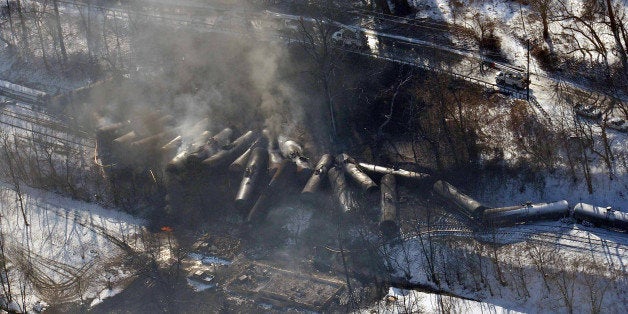 FILE-This aerial Feb. 17, 2015 file photo photo made available by the Office of the Governor of West Virginia shows a derailed train in Mount Carbon, WVa. As investigators in West Virginia and Ontario pick through the wreckage from the latest pair of oil train derailments to result in massive fires, U.S. transportation officials predict many more catastrophic wrecks involving flammable fuels in coming years absent new regulations. (AP Photo/ Office of the Governor of West Virginia, Steven Wayne Rotsch,File)