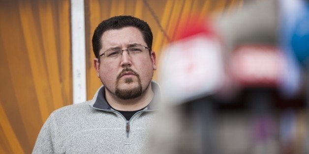 WASHINGTON, USA - MARCH 14: Mayor James Knowles, Mayor of Ferguson, stands with members of the business community during a press conference in Ferguson, USA on March 14, 2015. (Photo by Samuel Corum/Anadolu Agency/Getty Images)