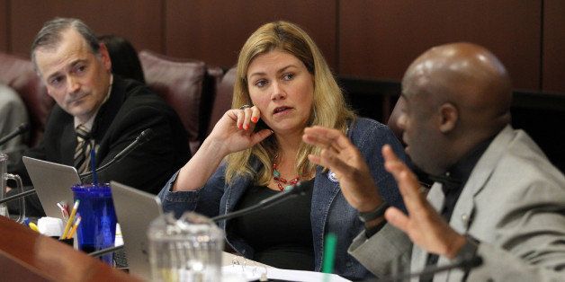 Nevada Senate Commerce committee members, from left, James Settelmeyer, R-Minden, Patriciat Farley, R-Las Vegas, and Kelvin Atkinson, D-Las Vegas, debate a move to increase Nevada's minimum wage during a hearing at the Legislative Building in Carson City, Nev., on Friday, March 20, 2015. (AP Photo/Cathleen Allison)