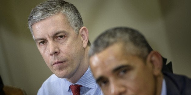 US Secretary of Education Arne Duncan (L) listens while US President Barack Obama makes a statement to the press after a meeting with the Council of the Great City Schools Leadership in the Roosevelt Room of the White House March 16, 2015 in Washington, DC. Obama spoke about the education budget. AFP PHOTO/BRENDAN SMIALOWSKI (Photo credit should read BRENDAN SMIALOWSKI/AFP/Getty Images)