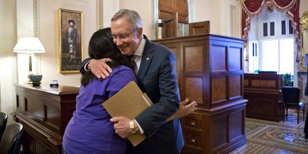 Senate Majority Leader Harry Reid, D-Nev., embraces Astrid Silva, of Las Vegas, at the Capitol in Washington,...