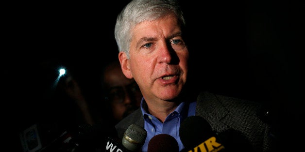 DETROIT, MI - MAY 21: Michigan Governor Rick Snyder speaks speaks to reporters after a luncheon May 21, 2014 in Detroit, Michigan. JP Morgan Chase CEO Jamie Dimon announced during the luncheon that JP Morgan Chase will invest $100-million to help the city of Detroit with blight removal, urban development, home loans and retraining people in the work force. (Photo by Joshua Lott/Getty Images)