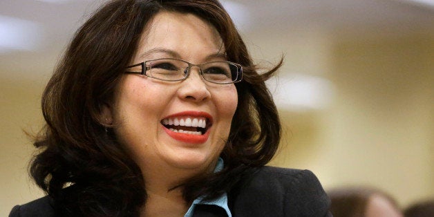 U.S. Rep. Tammy Duckworth, D-Ill., acknowledges applause from the crowd of supporters at the Illinois Democratic County Chairmen's Associations annual state fair Governor's Day brunch on Wednesday, Aug. 13, 2014, in Springfield, Ill. (AP Photo/Seth Perlman)