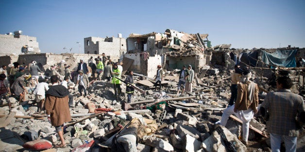 People search for survivors under the rubble of houses destroyed by Saudi airstrikes near Sanaa Airport, Yemen, Thursday, March 26, 2015. Saudi Arabia launched airstrikes Thursday targeting military installations in Yemen held by Shiite rebels who were taking over a key port city in the country's south and had driven the embattled president to flee by sea, security officials said. (AP Photo/Hani Mohammed)