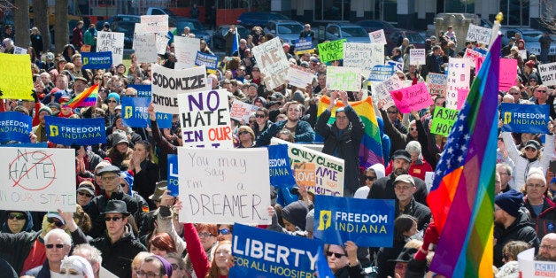 Thousands of opponents of Indiana Senate Bill 101, the Religious Freedom Restoration Act, gathered on the lawn of the Indiana State House to rally against that legislation Saturday, March 28, 2015. Republican Gov. Mike Pence signed a bill Thursday prohibiting state laws that "substantially burden" a person's ability to follow his or her religious beliefs. (AP Photo/Doug McSchooler)