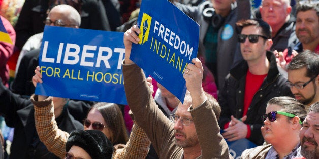 Thousands of opponents of Indiana Senate Bill 101, the Religious Freedom Restoration Act, gathered on the lawn of the Indiana State House to rally against that legislation Saturday, March 28, 2015. Republican Gov. Mike Pence signed a bill Thursday prohibiting state laws that "substantially burden" a person's ability to follow his or her religious beliefs. (AP Photo/Doug McSchooler)