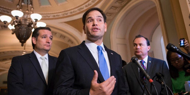 Sen. Marco Rubio, R-Fla., center, accompanied by Sen. Ted Cruz, R-Texas, left, and Sen. Mike Lee, R-Utah, speaks during a news conference on Capitol Hill in Washington, Friday, Sept. 27, 2013, to express their frustration after the Senate passed a bill to fund the government, but stripped it of the defund "Obamacare" language as crafted by House Republicans. The Republican-controlled House and the Democrat-controlled Senate are at an impasse as Congress continues to struggle over how to prevent a possible shutdown of the federal government when it runs out of money in three days. (AP Photo/J. Scott Applewhite)