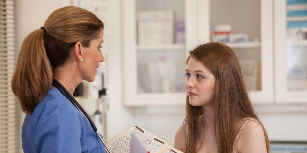 Doctor talking to patient in examination room