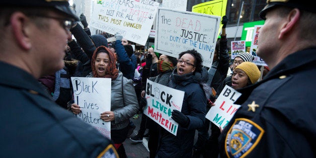 Demonstrators march in New York, Saturday, Dec. 13, 2014, during the Justice for All rally and march. In the past three weeks, grand juries have decided not to indict officers in the chokehold death of Eric Garner in New York and the fatal shooting of Michael Brown in Ferguson, Mo. The decisions have unleashed demonstrations and questions about police conduct and whether local prosecutors are the best choice for investigating police. (AP Photo/John Minchillo)