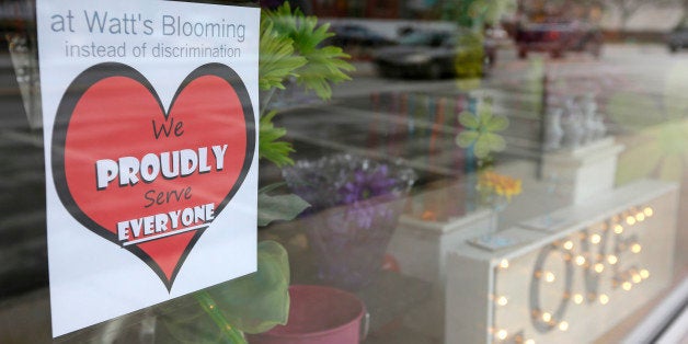 A window sign on a downtown Indianapolis florist, Wednesday, March 25, 2015, shows it's objection to the Religious Freedom bill passed by the Indiana legislature. Organizers of a major gamers' convention and a large church gathering say they're considering moving events from Indianapolis over a bill that critics say could legalize discrimination against gays. (AP Photo/Michael Conroy)