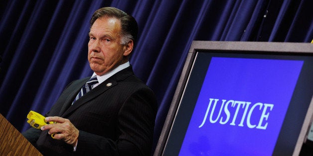 SANTA ANA , CA - SEPTEMBER 21: Orange County District Attorney Tony Rackauckas holds a taser gun as a prop during a news conference to announce that two Fullerton, California police officers were charged in connection with the death of Kelly Thomas, a schizophrenic homeless man who died after the altercation with several police officers, on September 21, 2011 in Santa Ana, California. Officer Manuel Ramos was charged with second-degree murder and involuntary manslaughter, while Cpl. Jay Cicinelli was charged with involuntary manslaughter and use of excessive force. (Photo by Kevork Djansezian/Getty Images)