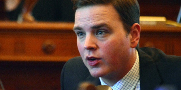 Kansas state Sen. Michael O'Donnell, a Wichita Republican, speaks to a colleague during the Senate's session, Tuesday, March 24, 2015, at the Statehouse in Topeka, Kan. O'Donnell was among senators opposed to a proposal to block state agencies and school districts from deducting charitable contributions for workers directly from their paychecks. (AP Photo/Nicholas Clayton)