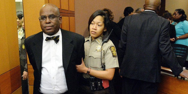 Donald Bullock, left, former Atlanta Public Schools Usher-Collier Heights Elementary testing coordinator, is led to a holding cell after a jury found him guilty in the Atlanta Public Schools test-cheating trial, Wednesday, April 1, 2015, in Atlanta. Bullock and 10 other former Atlanta Public Schools educators accused of participating in a test cheating conspiracy that drew nationwide attention were convicted Wednesday of racketeering charges. (AP Photo/Atlanta Journal-Constitution, Kent D. Johnson, Pool)