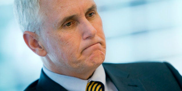 Michael 'Mike' Pence, governor of Indiana, pauses during an interview in New York, U.S., on Thursday, May 16, 2013. The largest-ever U.S. municipal junk bond sale remains in limbo after Indiana learned that a Pakistani company backing a fertilizer plant financed by the biggest borrowing in state history is linked to explosives causing the most U.S. casualties in Afghanistan. Photographer: Andrew Harrer/Bloomberg via Getty Images 