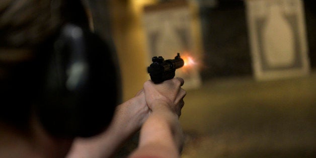 CENTENNIAL, CO. - JULY 27: Catherine Williams fires her handgun during a Multi-State Concealed Carry class at the Centennial