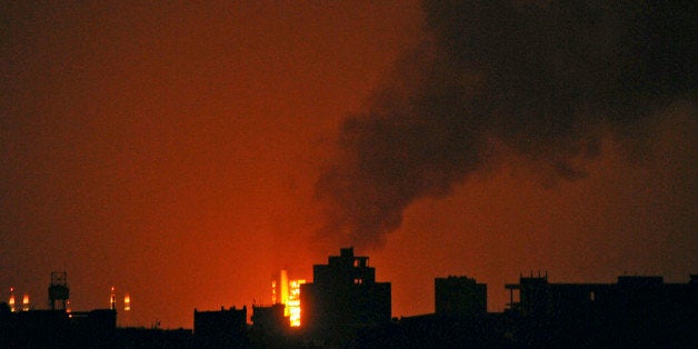 FILE - In this Thursday, June 2, 2011 file photo, fire and smoke erupt during clashes between tribesmen loyal to Sheik Sadeq al-Ahmar, the head of the powerful Hashid tribe, and Yemeni security forces in Sanaa, Yemen. What appeared an unstoppable groundswell for change across the Middle East earlier this year, has splintered into scattered and indecisive conflicts that have left thousands dead and Western policy makers juggling roles ranging from NATO airstrikes in Libya to worried bystanders in Syria and Yemen.(AP Photo/Mohammed Hamoud, File)