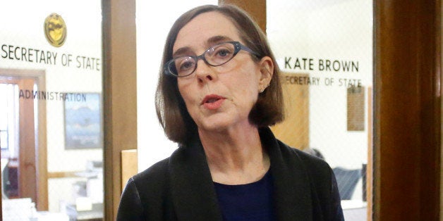 FILE - In this Feb. 13, 2015 file photo, Oregon Secretary of State Kate Brown speaks to the media outside of her office at th