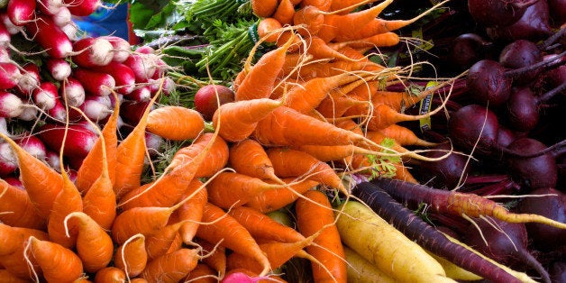 This photo taken on Oct. 5, 2013 shows radishes, carrots, turnips, and beets, at a farmer's market near Langley, Wash. Cool s