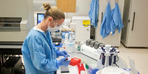 A forensic scientist works in a laboratory processing evidence during a visit by Camilla, the Duchess of Cornwall, Thursday, March 19, 2015, at the Department of Forensic Sciences in Washington. (AP Photo/Manuel Balce Ceneta)