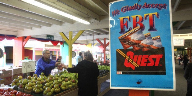 In this photo taken Saturday, Feb. 6, 2010, a sign announcing the acceptance of electronic Benefit Transfer cards is seen at a farmers market in Roseville, Calif. Currently food stamp recipients have had problems purchasing food at farmer's markets because many of them do not accept the EBT cards that food stamp recipients use to buy groceries. A bill currently in the legislature would change that by helping farmers markets overcome bureaucratic hurdles to obtain the equipment needed to read the benefit cards.(AP Photo/Rich Pedroncelli)