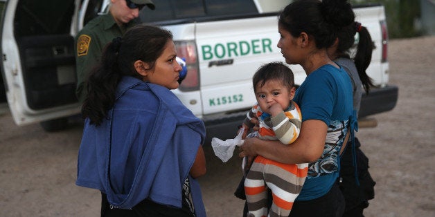 MCALLEN, TX - SEPTEMBER 08: Families of Central American immigrants turn themselves in to U.S. Border Patrol agents after crossing the Rio Grande River from Mexico on September 8, 2014 to McAllen, Texas. Although the numbers of such immigrant families and unaccompanied minors have decreased from a springtime high, thousands continue to cross in the border illegally into the United States. The Rio Grande Valley sector is the busiest area for illegal border crossings, especially for Central Americans, into the U.S. (Photo by John Moore/Getty Images)