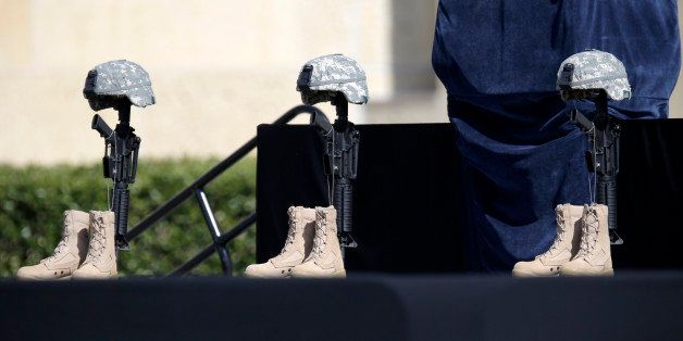 A military memorial display for for fallen soldiers is seen prior to a service where President Barack Obama will attend, Wednesday, April 9, 2014, at Fort Hood, Texas. The shooting rampage left four dead and more than a dozen injured. President Barack Obama is reprising his role as chief comforter as he returns once again to a grief-stricken corner of America to mourn with the families of those killed last week at Fort Hood and offer solace to the nation. (AP Photo/Eric Gay)