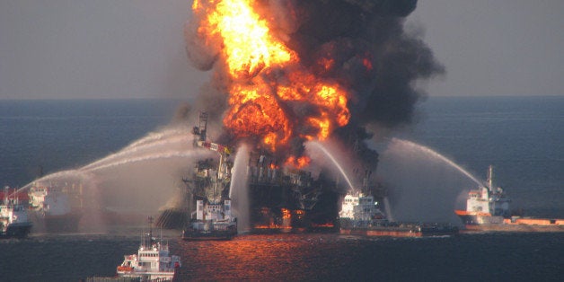 FILE - In this April 21, 2010 file photo provided by the U.S. Coast Guard, fire boat response crews spray water on the blazing remnants of BP's Deepwater Horizon offshore oil rig. BP agreed late Friday March 2, 2012 to settle lawsuits brought by more than 100,000 fishermen who lost work, cleanup workers who got sick and others who claimed harm from the oil giant's 2010 Gulf of Mexico disaster, the worst offshore oil spill in the nation's history. The momentous settlement will have no cap to compensate the plaintiffs, though BP PLC estimated it would have to pay out about $7.8 billion, making it one of the largest class-action settlements ever. After the Exxon Valdez disaster in 1989, the company ultimately settled with the U.S. government for $1 billion, which would be about $1.8 billion today. (AP Photo/US Coast Guard, File)