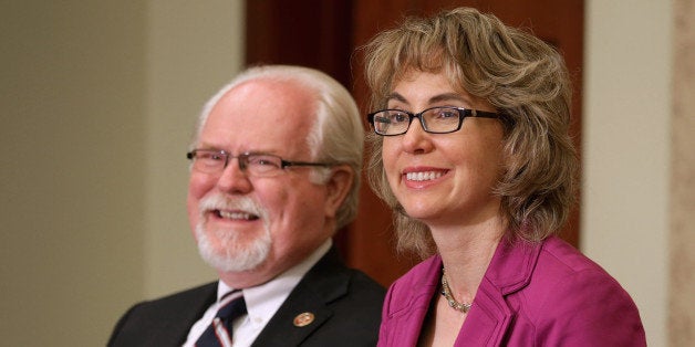 WASHINGTON, DC - APRIL 16: U.S. Rep. Ron Barber (D-AZ) (L) and former U.S. Rep. Gabrielle Giffords (D-AZ) attend the dedication ceremony of the Gabriel Zimmerman Meeting Room in the U.S. Capitol Visitors Center April 16, 2013 in Washington, DC. A member of Giffords' Congressional staff, Gabriel Zimmerman was murdered during a shooting spree January 8, 2011 that left six dead and 13 injured, including Giffords. (Photo by Chip Somodevilla/Getty Images)