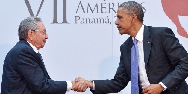 US President Barack Obama (R) shakes hands with Cuba's President Raul Castro during a meeting on the sidelines of the Summit