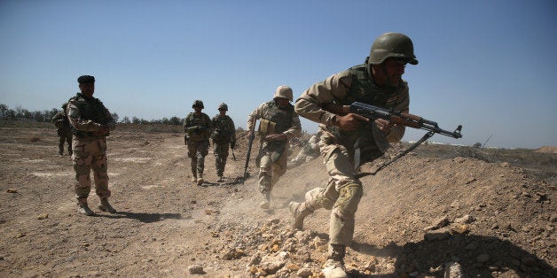 TAJI, IRAQ - APRIL 12: U.S. Army trainers instruct Iraqi Army recruits at a military base on April 12, 2015 in Taji, Iraq. U.S. forces, currently operating in 5 large bases throught Iraq, are training thousands of Iraqi Army combat troops, trying to rebuild a force they had origninally trained before the U.S. withdrawal from Iraq in 2010. Members of the U.S. Army's 5-73 CAV, 3BCT, 82nd Airborne Division are teaching members of the newly-formed 15th Division of the Iraqi Army, as the Iraqi government launches offensives to try to recover territory lost to ISIS last year. (Photo by John Moore/Getty Images)