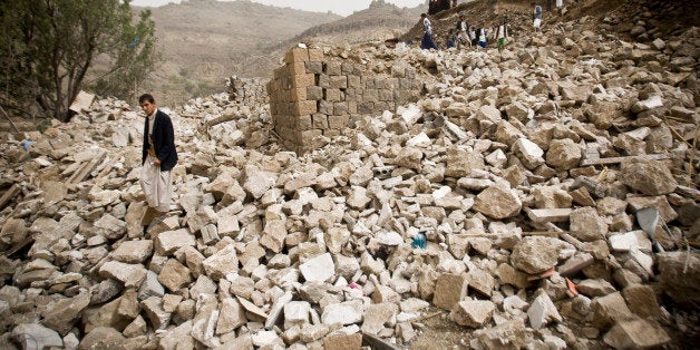 FILE - In this Saturday, April 4, 2015 file photo, Yemenis search for survivors in the rubble of houses destroyed by Saudi-l