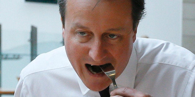 Britain's Prime Minister David Cameron, left, and his wife Samantha eat breakfast during a visit to financial firm Scottish