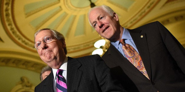 WASHINGTON, DC - NOVEMBER 18: Senate Minority Leader Mitch McConnell (L) (R-KY) answers questions with members of the Republican senate leadership following the weekly Republican policy luncheon at the U.S. Capitol November 18, 2014 in Washington, DC. Members of the leadership discussed a possible vote of the Keystone XL pipeline that may take place later today. Also pictured is Sen. John Cornyn (R) (R-TX). (Photo by Win McNamee/Getty Images)