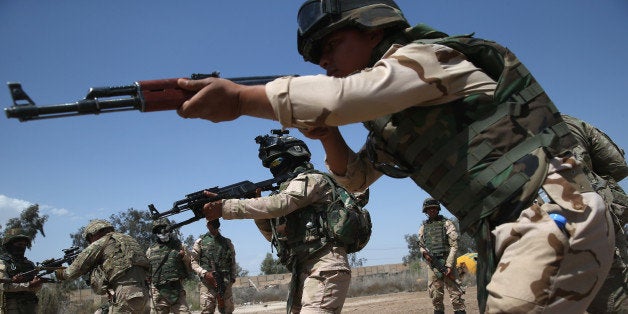 TAJI, IRAQ - APRIL 12: Iraqi Army recruits train with U.S. Army trainers at a military base on April 12, 2015 in Taji, Iraq. U.S. forces, currently operating in 5 large bases throught the country, are training thousands of Iraqi Army combat troops, trying to rebuild a force they had origninally trained before the U.S. withdrawal from Iraq in 2010. Members of the U.S. Army's 5-73 CAV, 3BCT, 82nd Airborne Division are teaching members of the newly-formed 15th Division of the Iraqi Army, as the Iraqi government launches offensives to try to recover territory lost to ISIS last year. (Photo by John Moore/Getty Images)