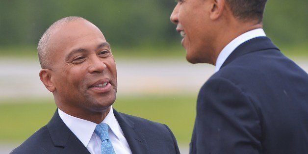 US President Barack Obama chats with Massachusetts Governor Deval Patrick (L) upon arrival at Worcester Regional Airport in Worcester, Massachusetts on June 11, 2014. Obama is in Worcester to speak at a high school commencement and will travel to Weston, Massachusetts, to attend a fundraiser. AFP PHOTO/Mandel NGAN (Photo credit should read MANDEL NGAN/AFP/Getty Images)