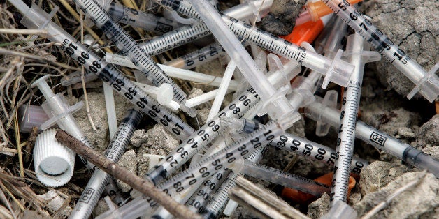 Used syringes and needles are piled on the ground under an underpass on the west side of San Antonio where drug addicts shoot up, Thursday, May 22, 2008. Bill Day of San Antonio has been the addict's source for clean needles with a needle-exchange program with the goal of keeping them from spreading disease. The Bexar County district attorney, backed by an opinion from the Texas attorney general, has said anyone who has drug paraphernalia, even as part of a needle-exchange service for the public good, is prosecutable. In January, Day and two colleagues were cited by police for their work. (AP Photo/Eric Gay)