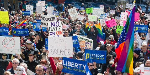 Thousands of opponents of Indiana Senate Bill 101, the Religious Freedom Restoration Act, gathered on the lawn of the Indiana State House to rally against that legislation Saturday, March 28, 2015. Republican Gov. Mike Pence signed a bill Thursday prohibiting state laws that "substantially burden" a person's ability to follow his or her religious beliefs. (AP Photo/Doug McSchooler)